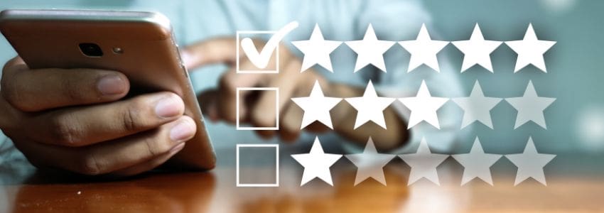 A candidate holding their cell phone an enlarged rating scale to the right of their photo indicting they giving the employer 5-stars.