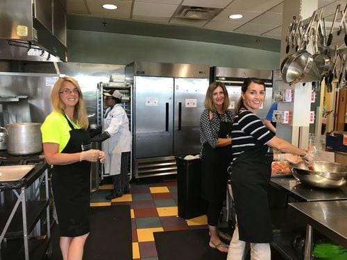 Robin Throckmorton, Alisa Fedders and Terry Salo preparing a meal at Ronald McDonald House