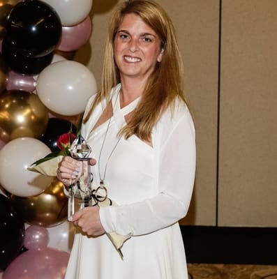 PHOTO of Robin Throckmorton, president of strategic HR inc., holding Woman Owned Business of Year Award- Clermont Chamber (2019)