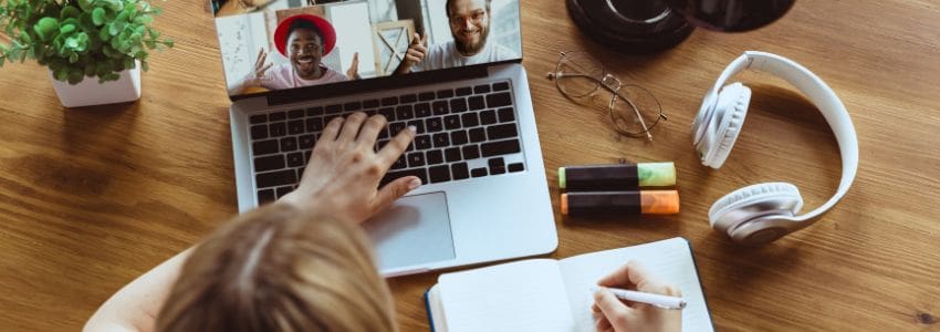 Remote worker taking notes on a video call