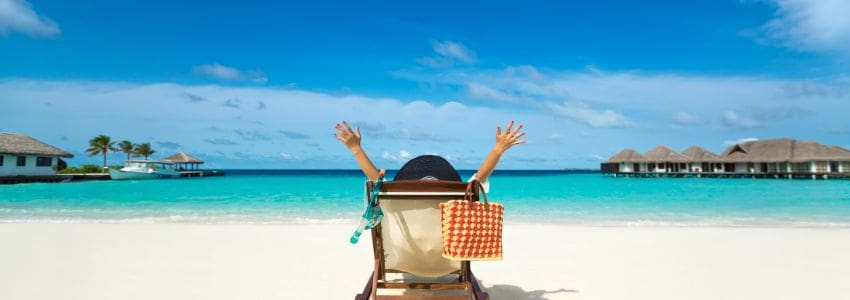 Employee sitting in a lounge chair at the beach