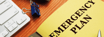Document with the words Emergency Plan on an office desk