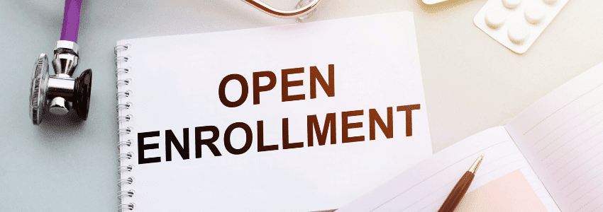 Notebook with words Open Enrollment along with pen and stephoscope
