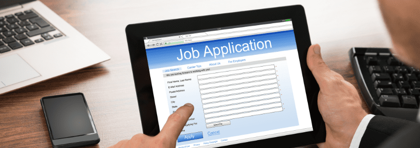 Man completing job application on tablet