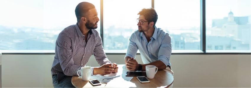 A manager and employee having a one-on-one meeting.