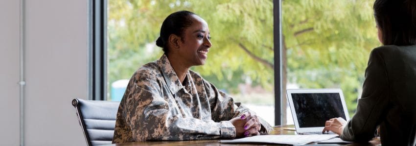 Recruiting sitting in her office in front of her laptop interviewing a veteran 