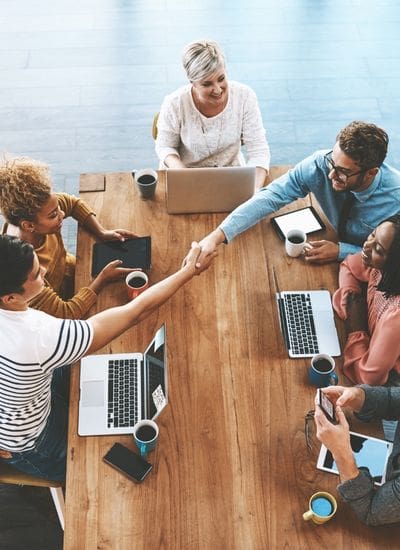 HR contractor shaking hands at a meeting with a client's team