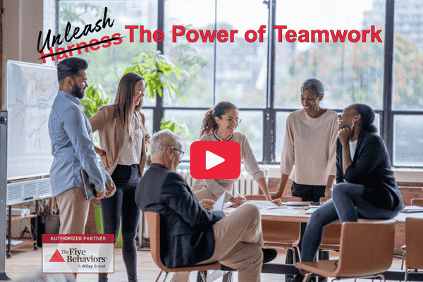 A team having a spirited discussion with a couple of team members laughing with the tagline: Unleash the power of teamwork